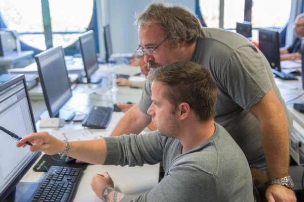 Teacher giving training course to job seekers (computer-aided design)